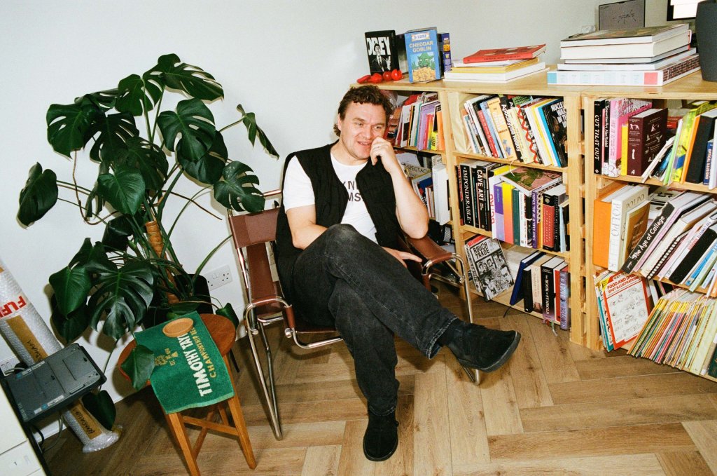 Craig Oldham by his bookcase